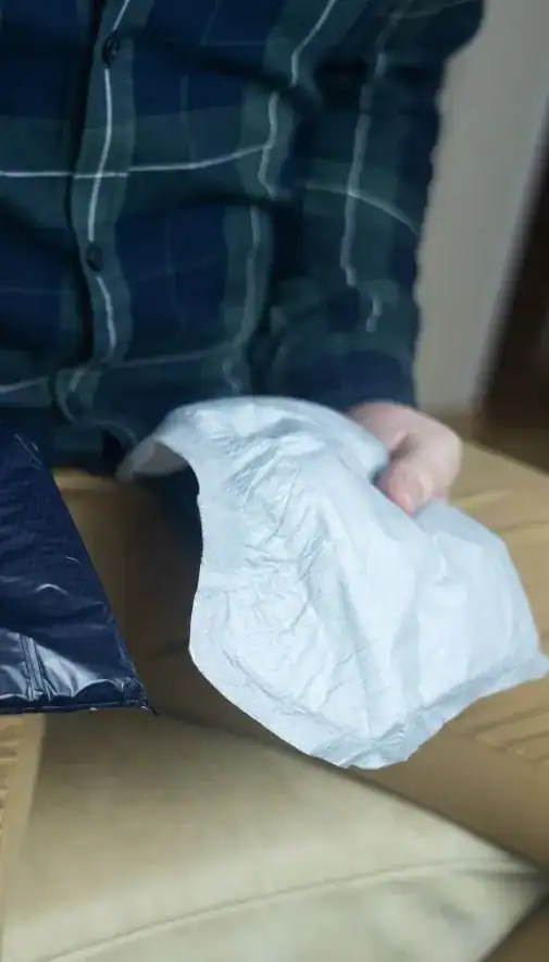 Image of man holding incontinence pads as part of overactive bladder treatment Newcastle upon Tyne